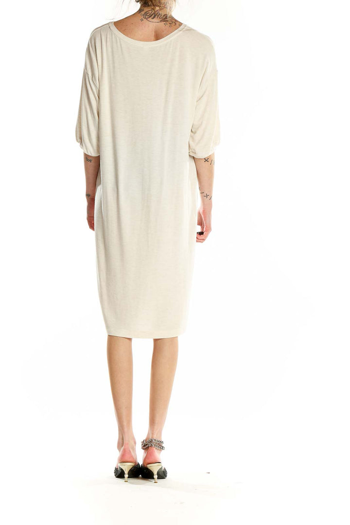 Back view of Uniqlo cream relaxed fit t-shirt dress on model