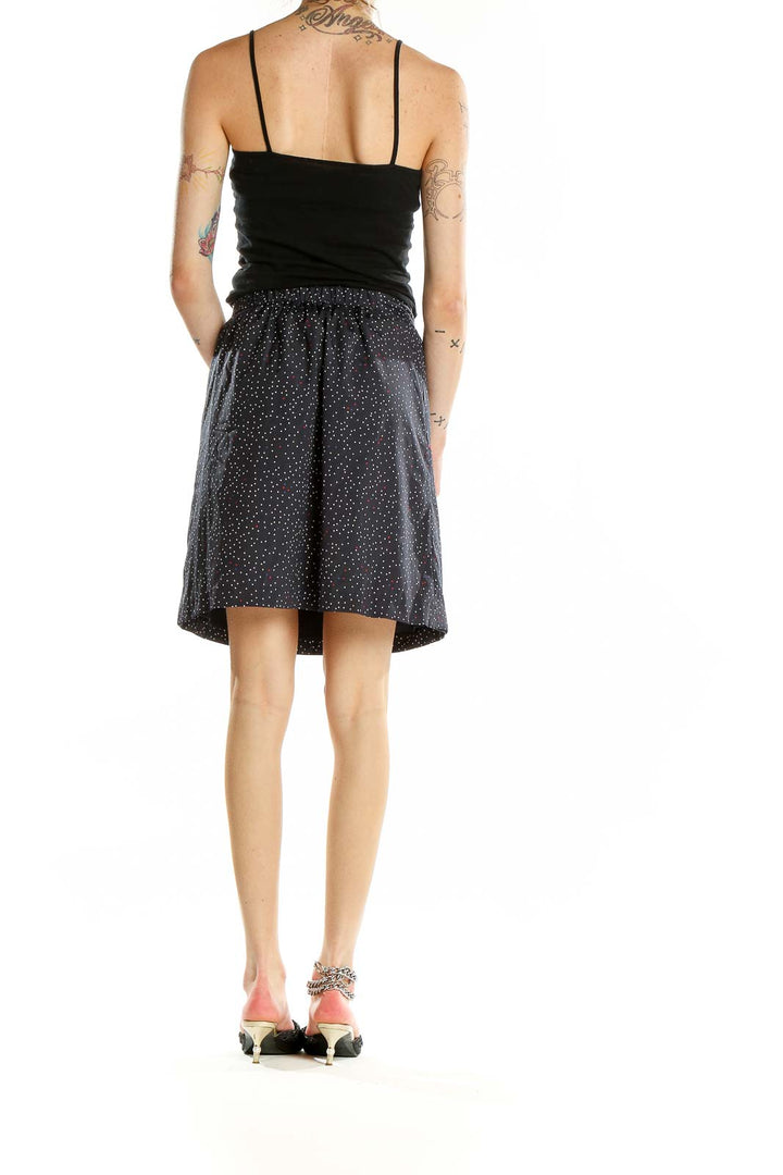 Back view of Tommy Hilfiger navy polka dot A-line skirt on model