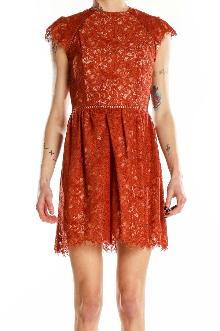 Front view of Style Stalker rust lace mini dress with cap sleeves and high neckline