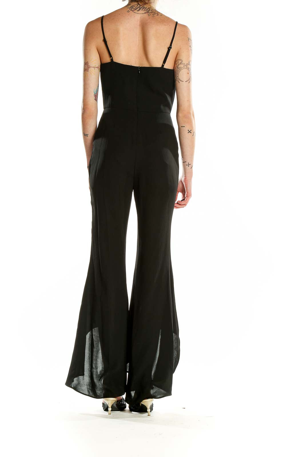 Back view of black Gianni Bini jumpsuit showing flared legs with high-low hems
