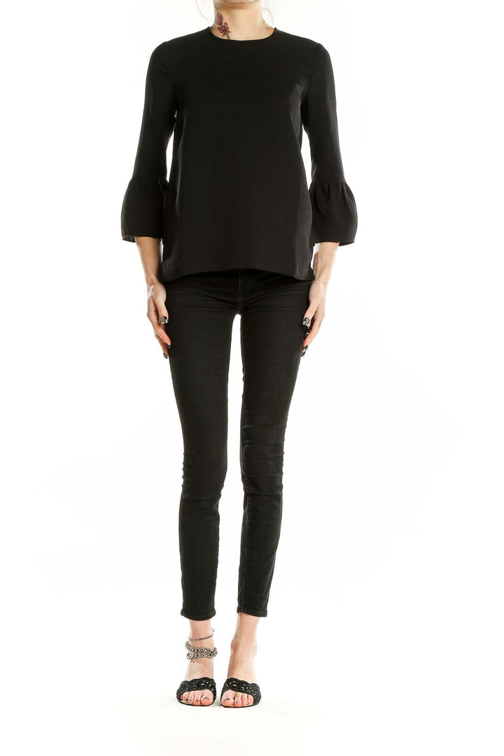 Front view of Madewell black polyester blouse with bell sleeves