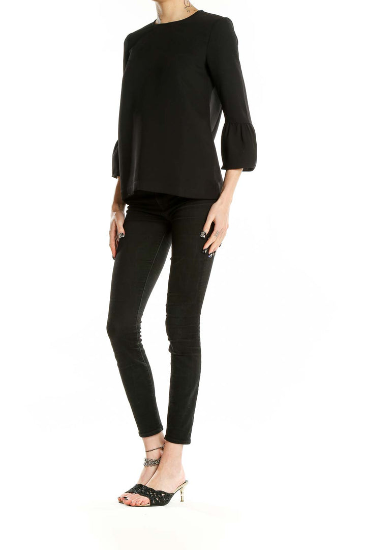 Front view of Madewell black polyester blouse with bell sleeves