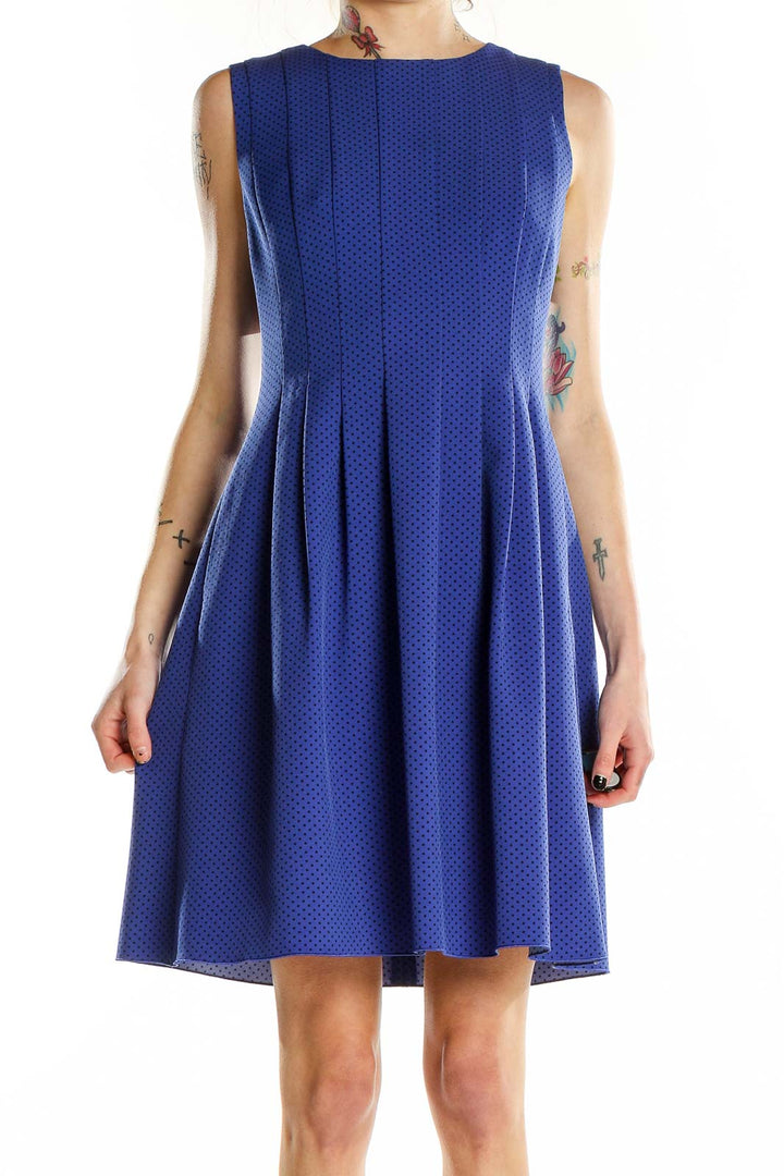 Front view of Anne Klein blue polka dot sleeveless dress with pleated skirt