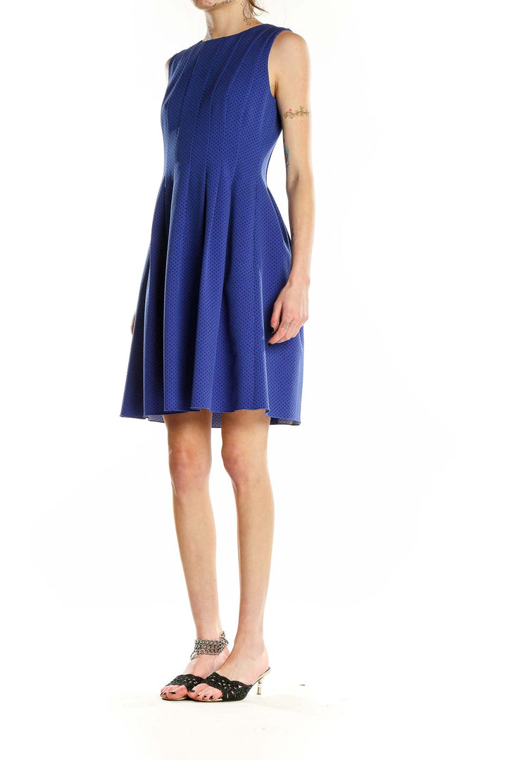 Front view of Anne Klein blue polka dot sleeveless dress with pleated skirt