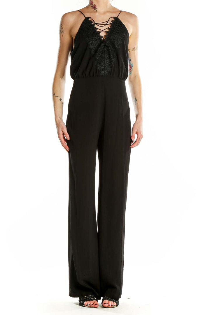 Front view of black Wayf jumpsuit with lace-up neckline and wide-leg pants