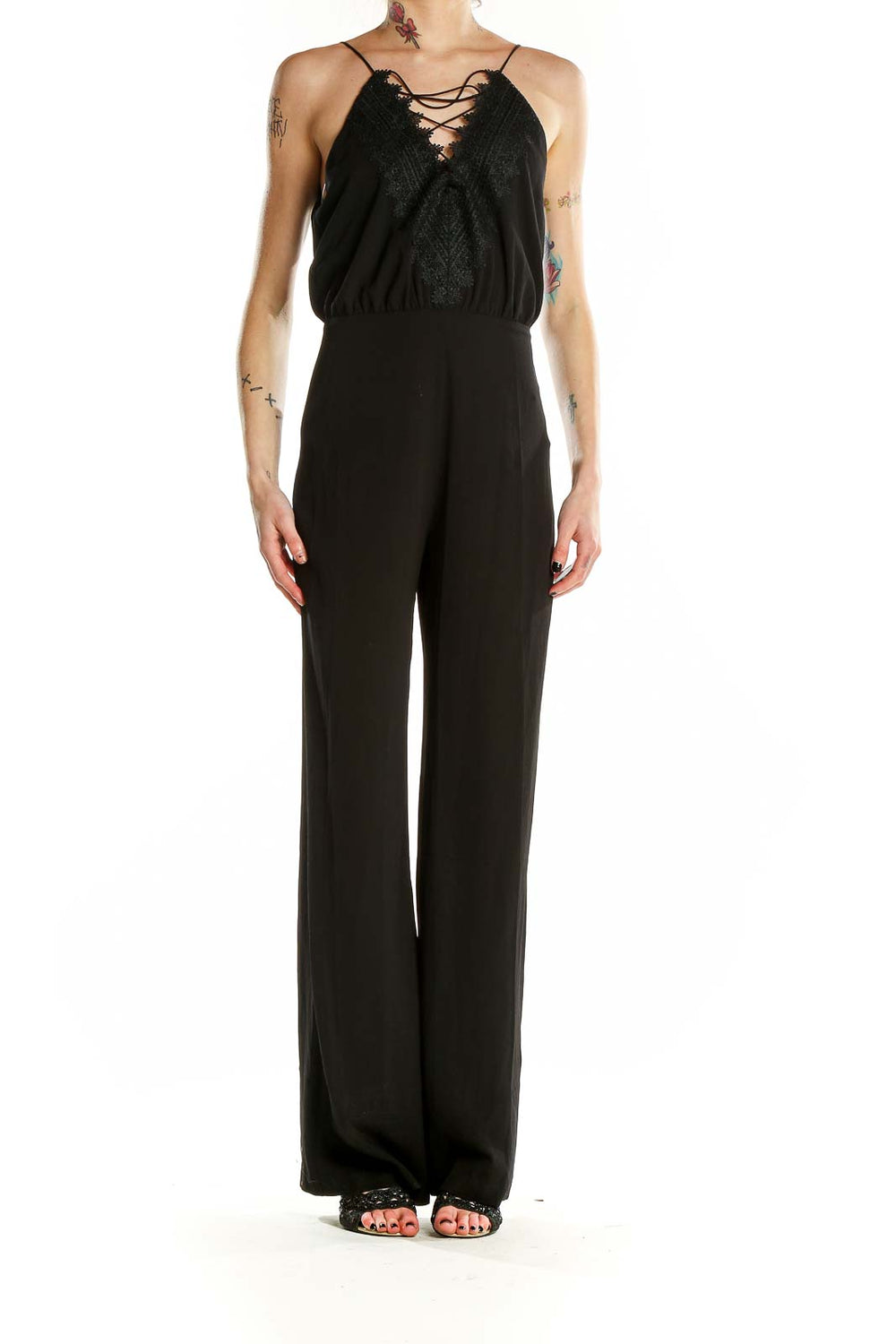 Front view of black Wayf jumpsuit with lace-up neckline and wide-leg pants