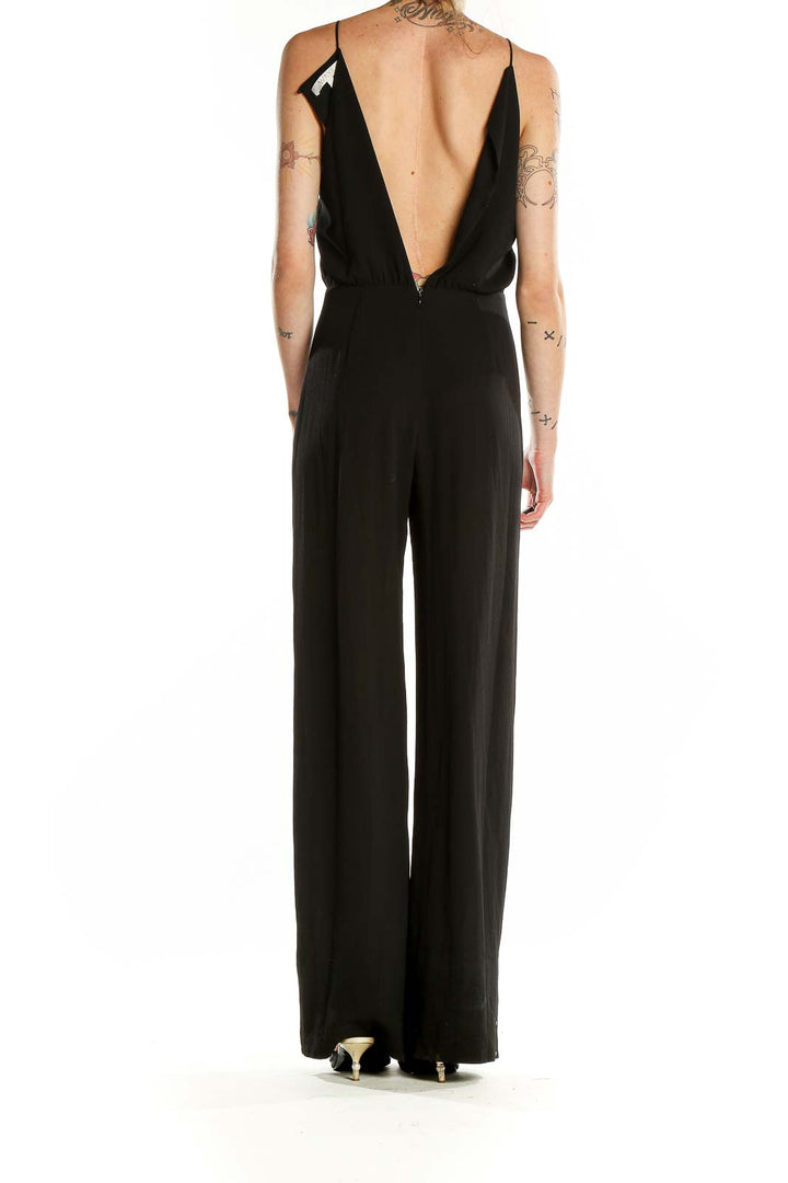 Back view of black Wayf jumpsuit showing deep V-back design