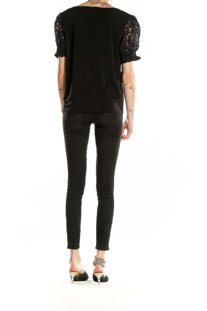 Back view of Adrianna Papell black top showing full length and fit