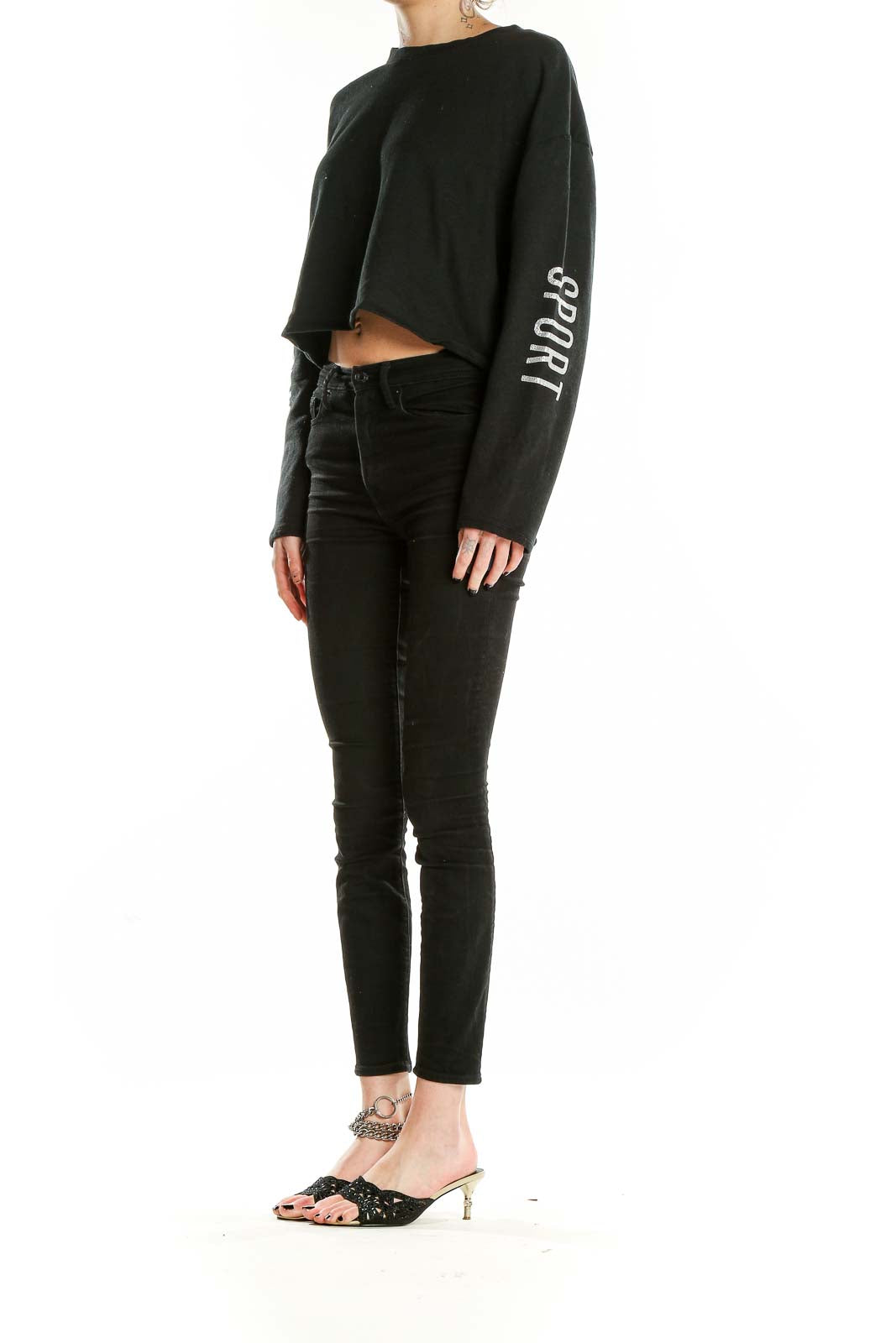 Front view of black Victoria Sport cropped long sleeve top with text on sleeves