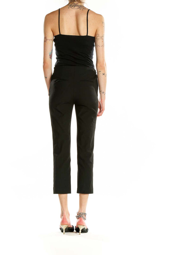 Back view of Ann Taylor Petites black cropped dress pants on model