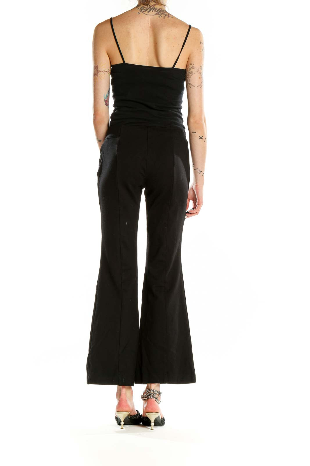 Back view of INC black wide-leg flare pants on model