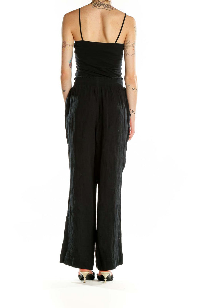 Back view of Sax Fifth Avenue black wide-leg pants showing relaxed fit