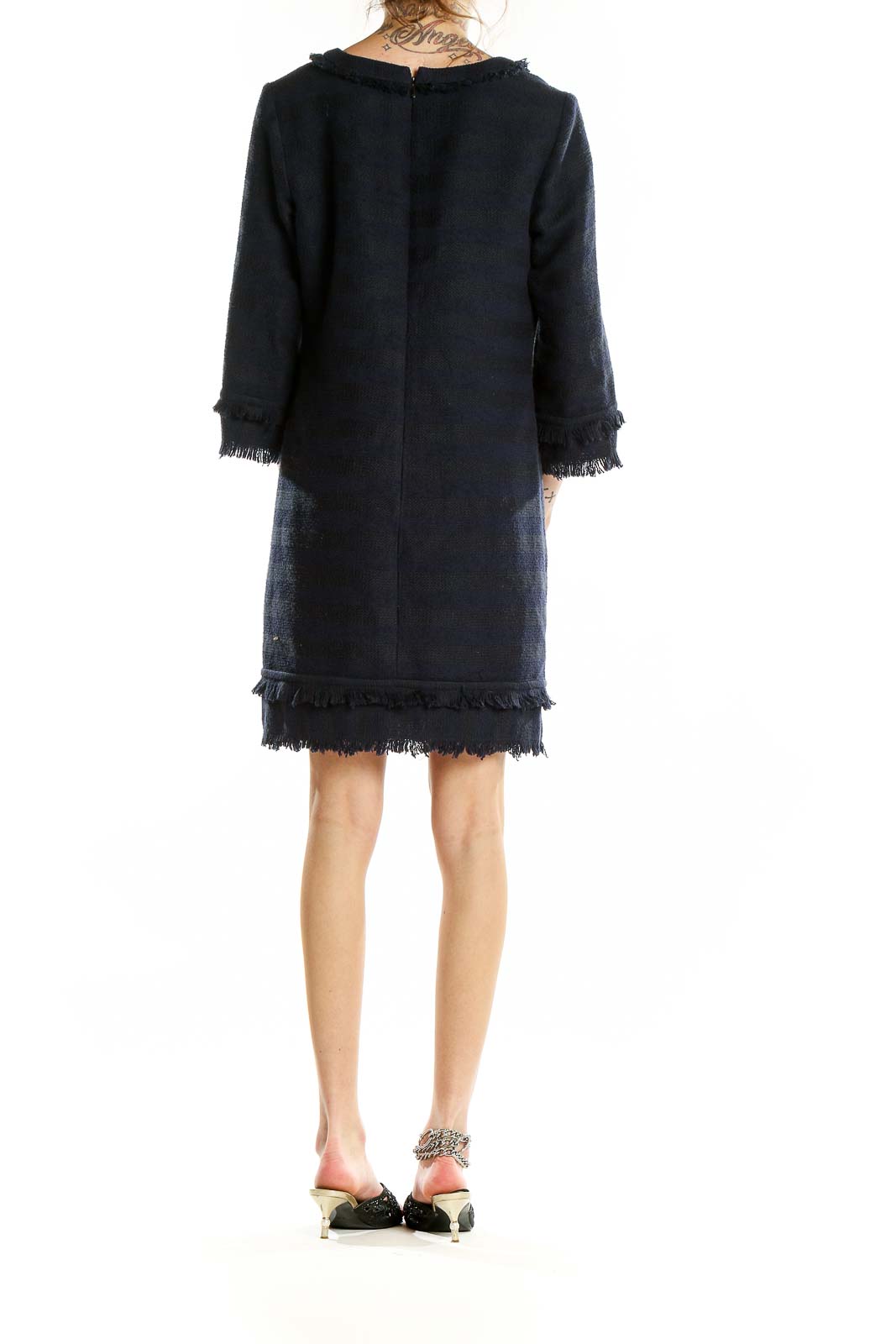 Back view of Trina Turk navy knit dress showing fringe trim hem