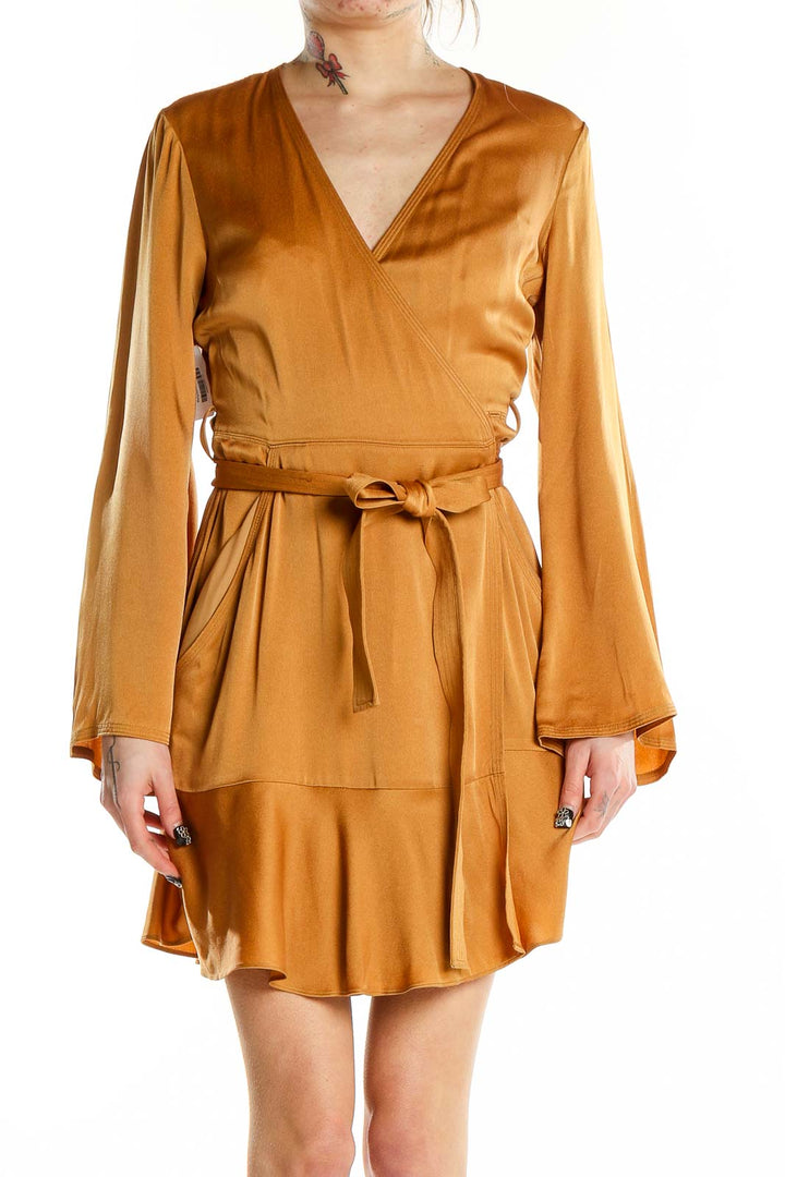 Front view of A.L.C. golden satin wrap mini dress with V-neckline and tie belt