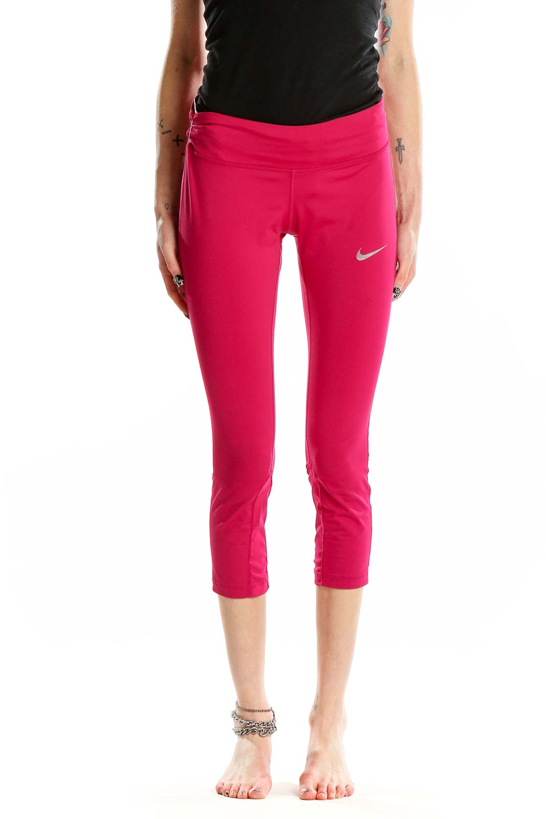 Front view of pink Nike cropped athletic leggings on model
