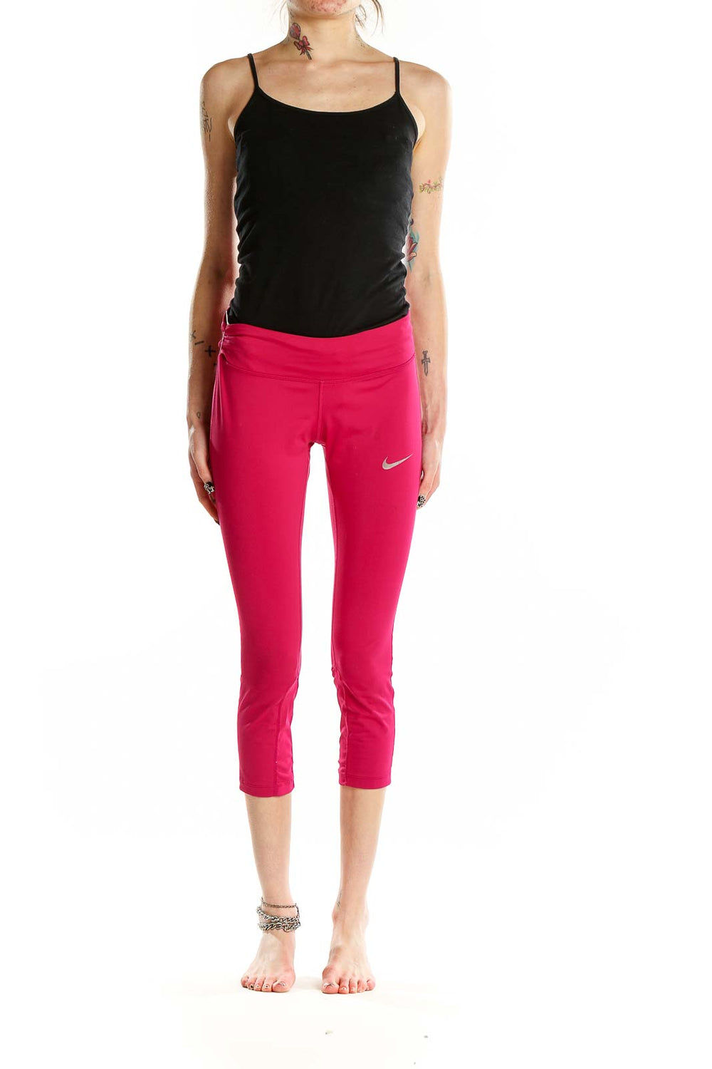 Front view of pink Nike cropped athletic leggings on model