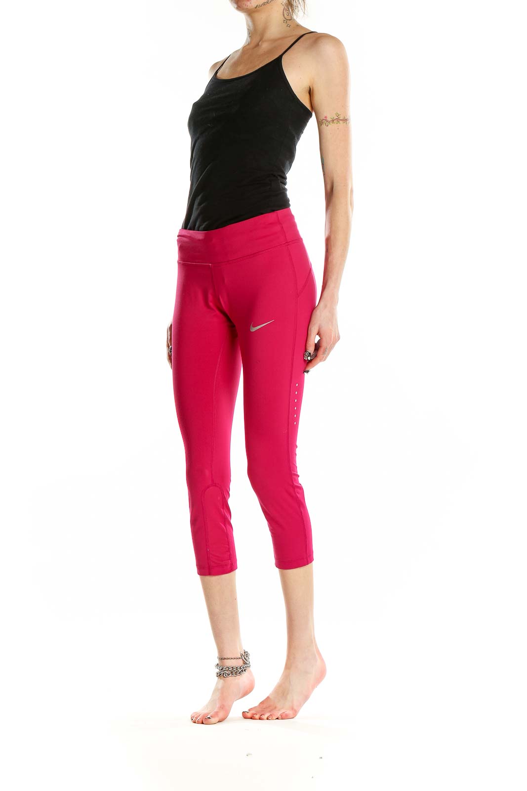 Front view of pink Nike cropped athletic leggings on model