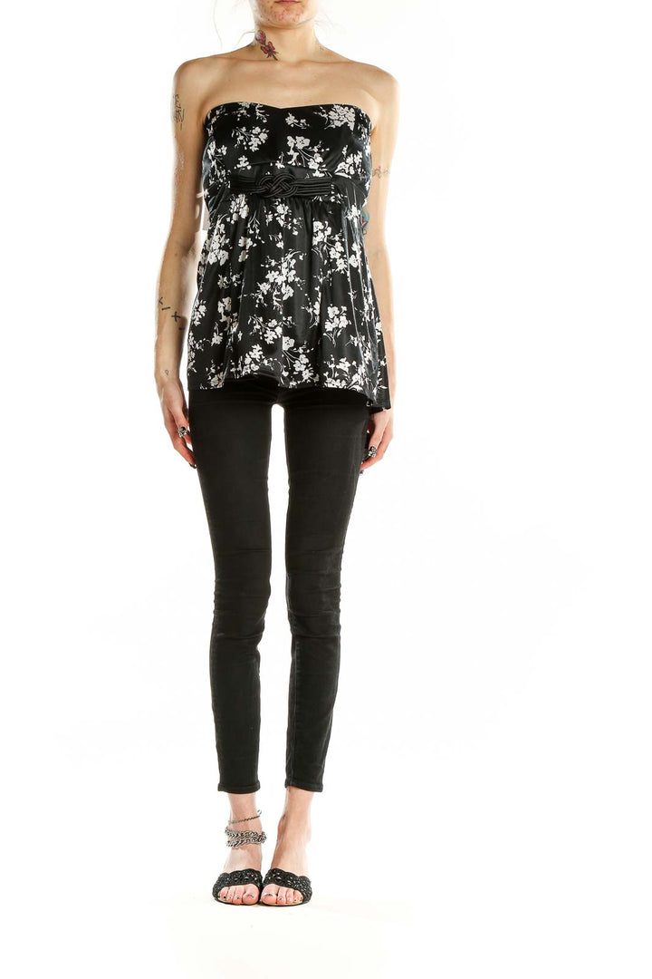 Front view of Torrid black strapless top with white floral print and empire waist