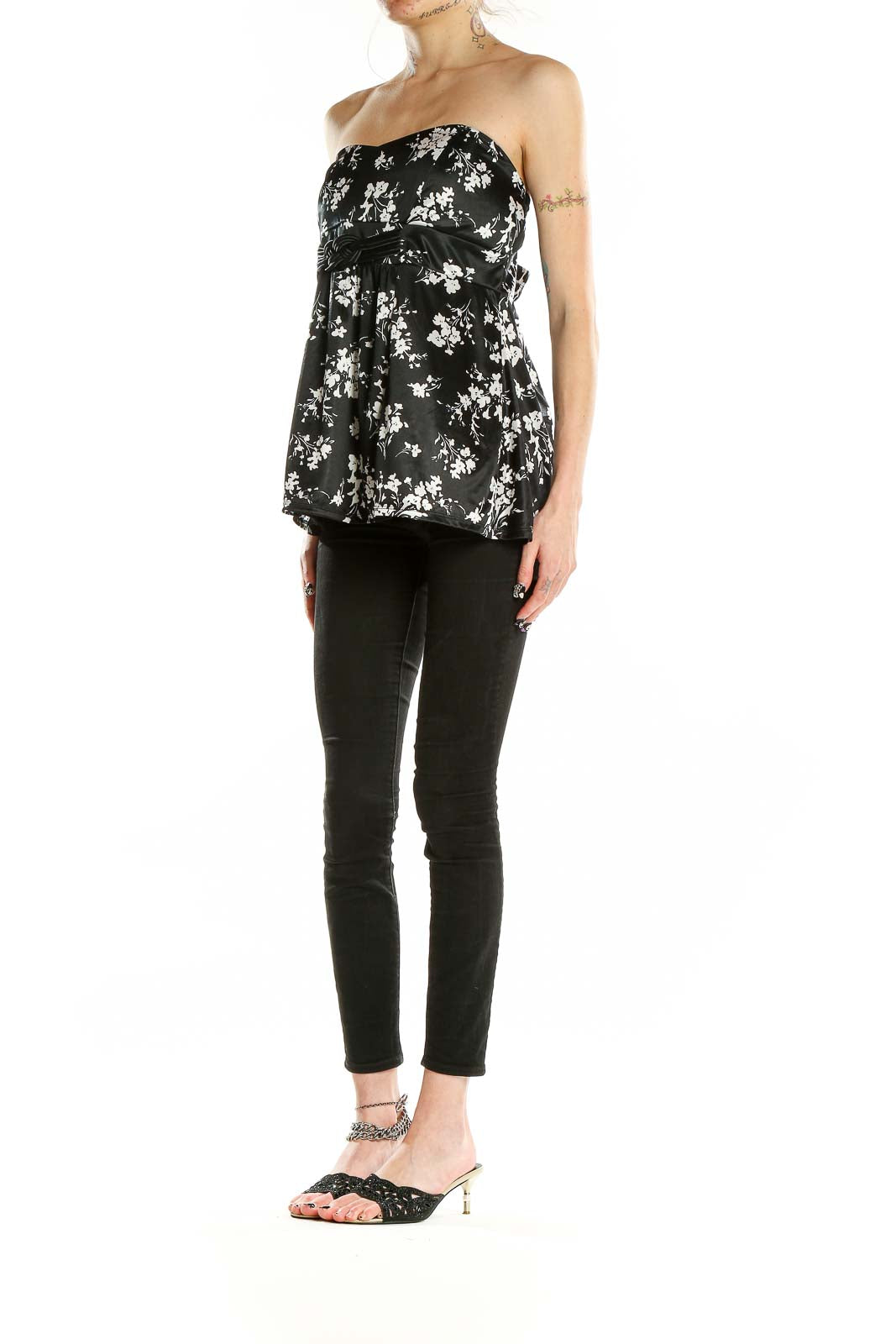 Front view of Torrid black strapless top with white floral print and empire waist
