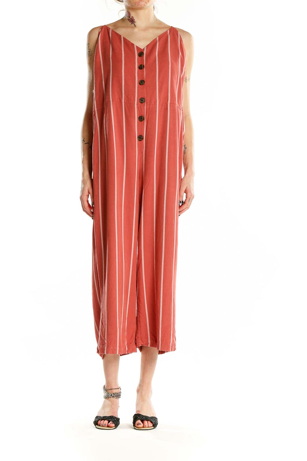 Front view of coral striped Gap jumpsuit with button-front closure