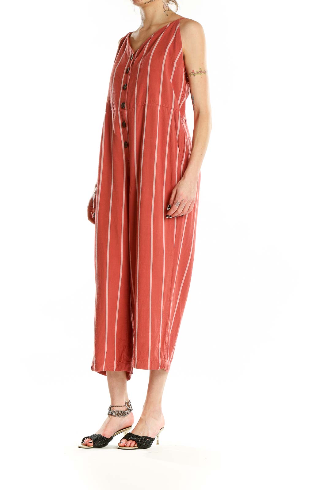 Front view of coral striped Gap jumpsuit with button-front closure