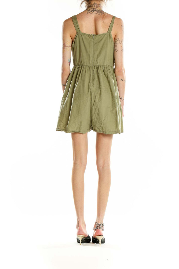 Back view of olive green cotton romper showing wide straps and gathered waist