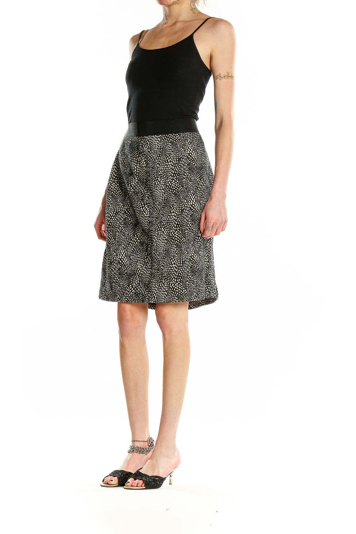 Front view of Ann Taylor black and white dotted A-line skirt