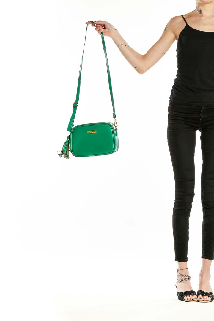 Front view of Joy & Iman green leather crossbody bag with tassel