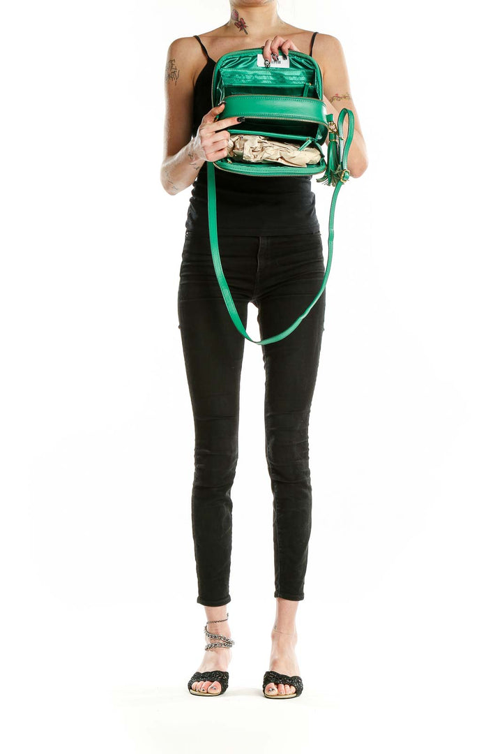 Interior view of Joy & Iman green leather crossbody bag showing compartments