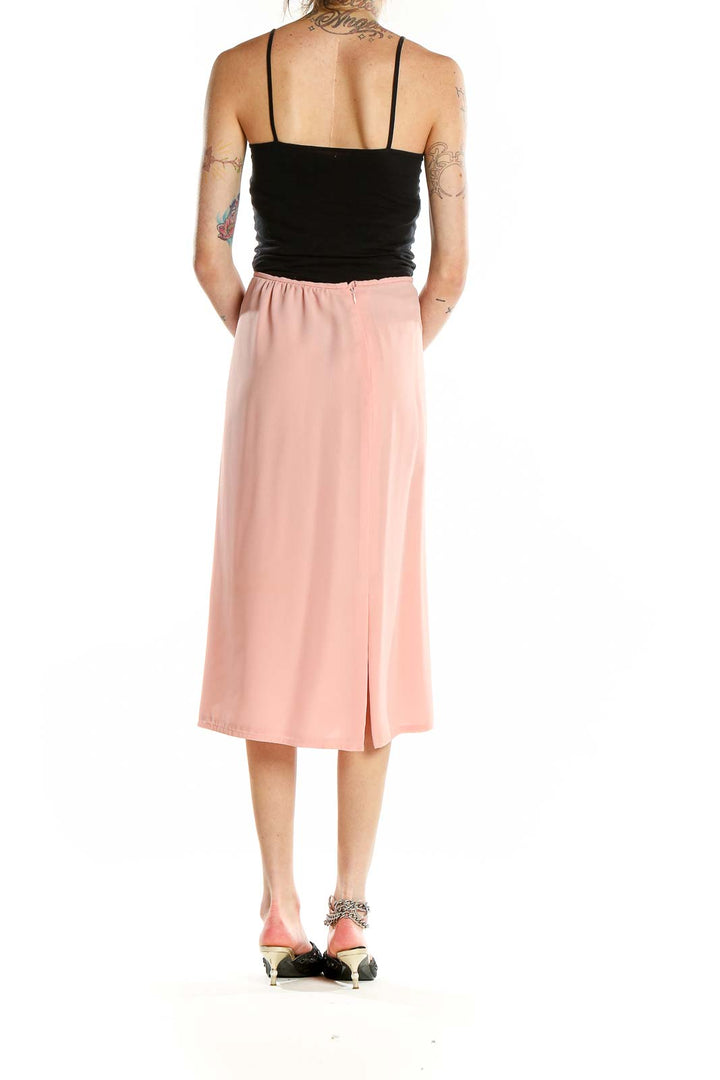 Back view of pink midi pencil skirt by SilkRoll showing subtle slit