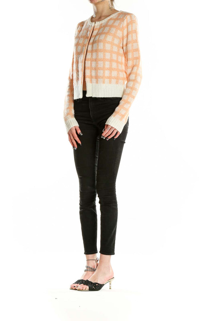 Front view of Calista peach checkered cropped cardigan with button closure