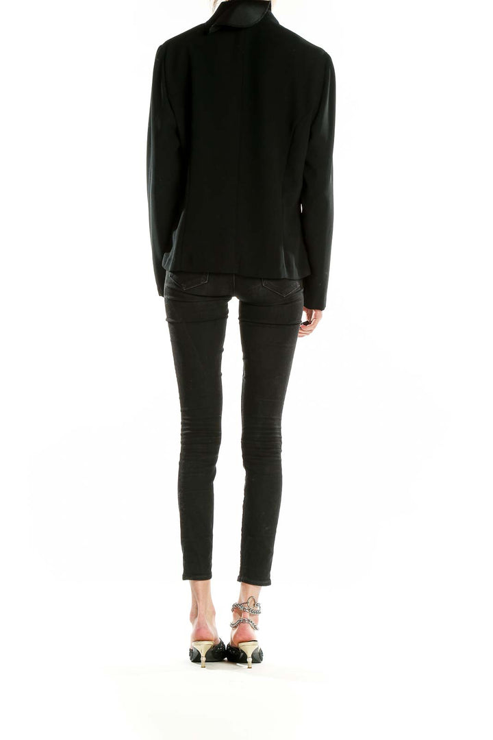 Back view of Miss Scarlett black polyester blazer on model with skinny jeans