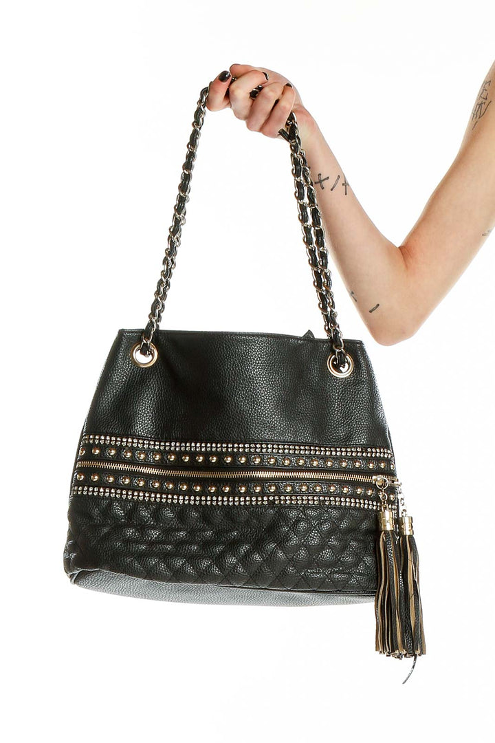 Front view of black quilted shoulder bag with gold studs and chain strap