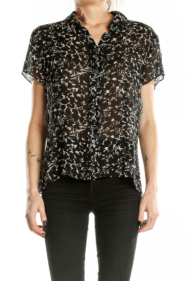 Front view of Ann Taylor black silk blouse with white floral print