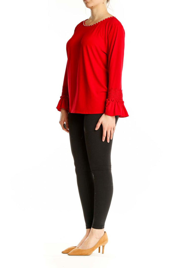 Front view of Karl Lagerfeld red top with embellished neckline and bell sleeves