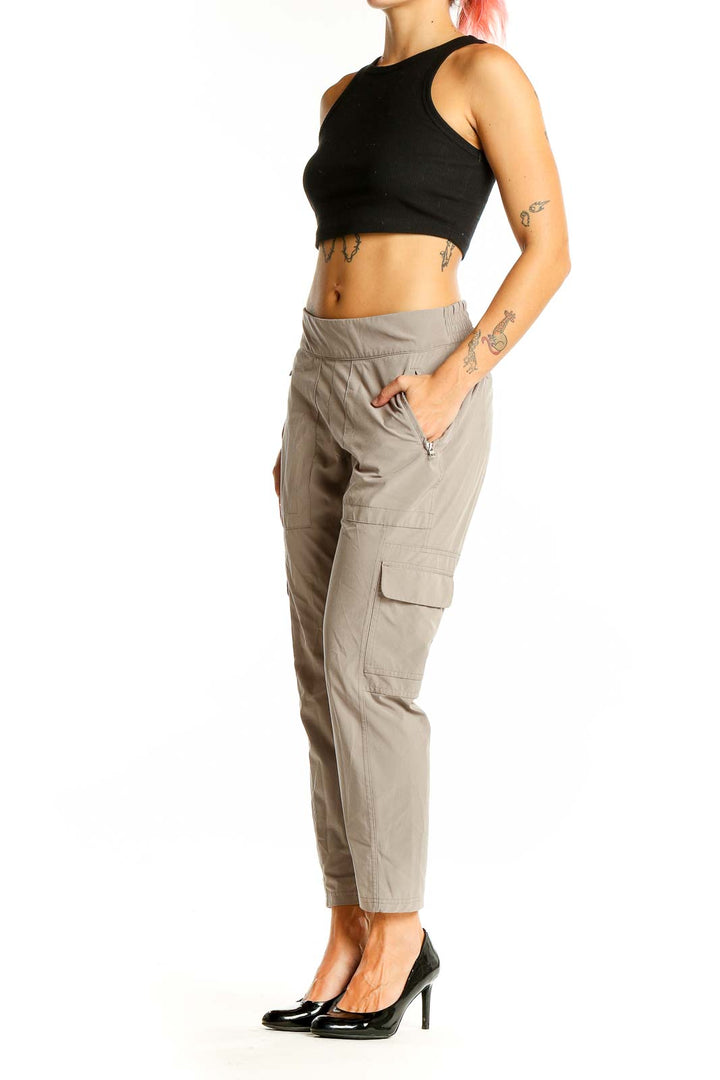 Front view of Athleta beige cargo-style athletic pants