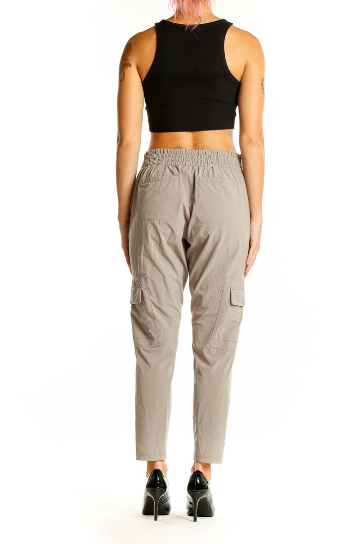 Back view of Athleta beige cargo-style athletic pants with elastic waistband