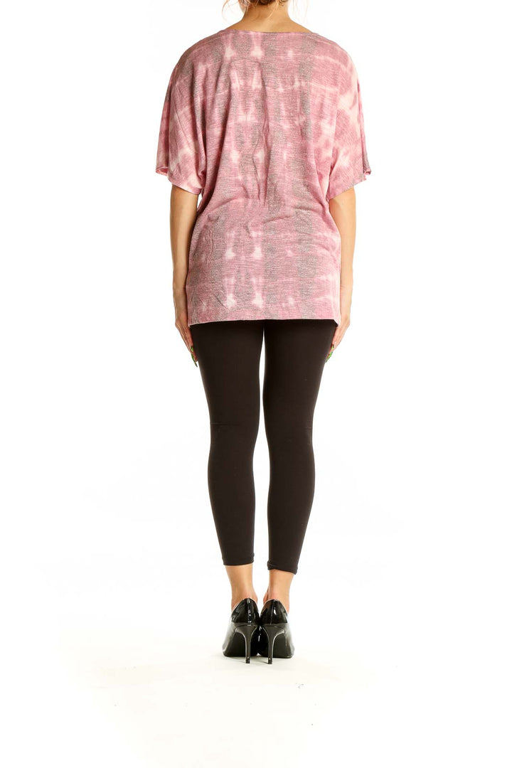 Back view of pink tie-dye oversized top showing dolman sleeves