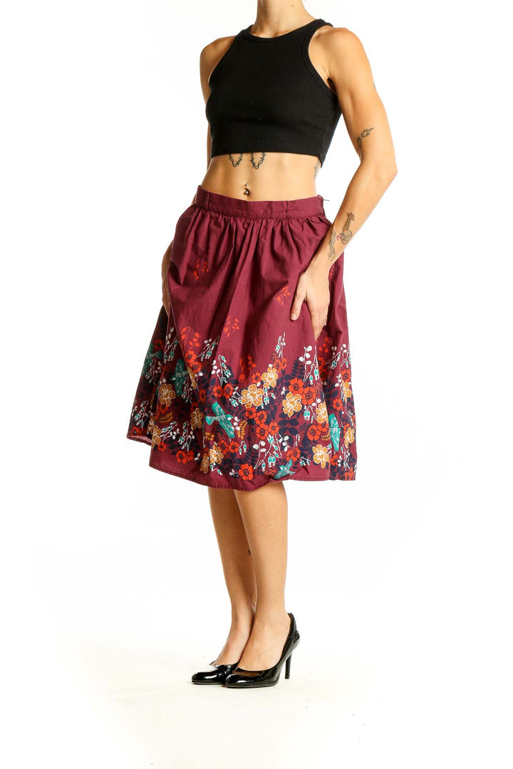 Front view of burgundy ModCloth cotton skirt with colorful floral print along hem