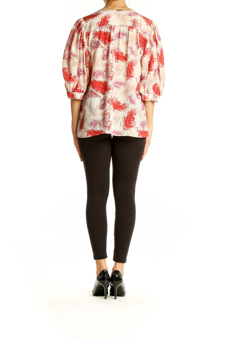 Back view of Tucker red feather print silk blouse showing relaxed fit