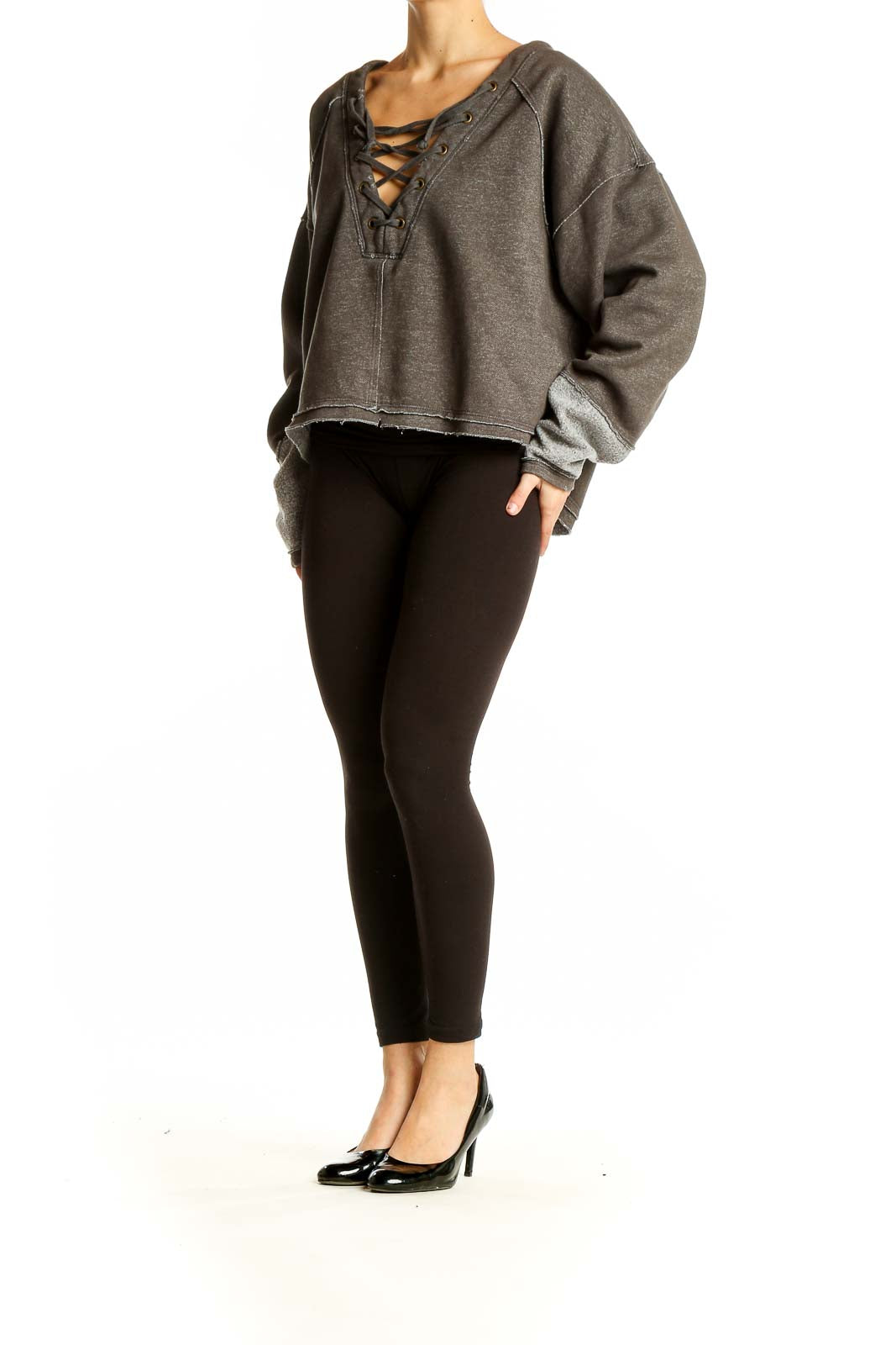 Front view of WE THE FREE gray cropped sweatshirt with lace-up V-neck