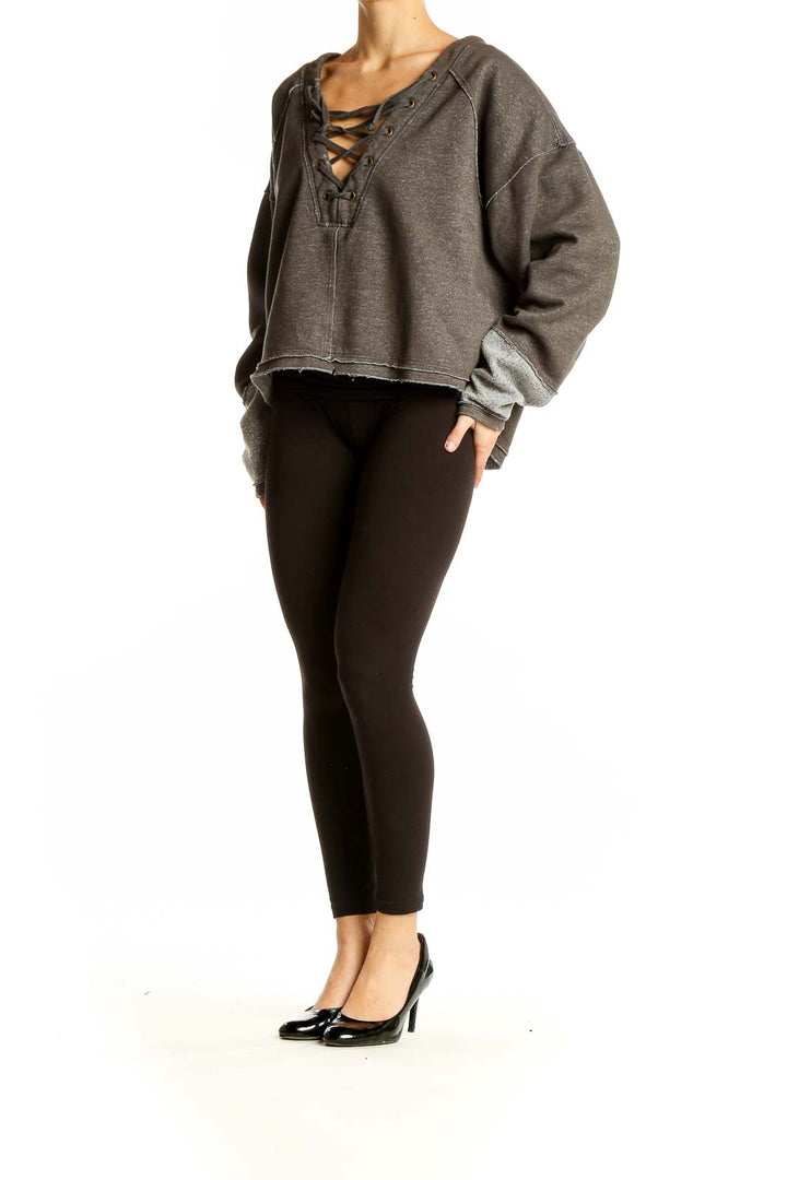 Front view of WE THE FREE gray cropped sweatshirt with lace-up V-neck
