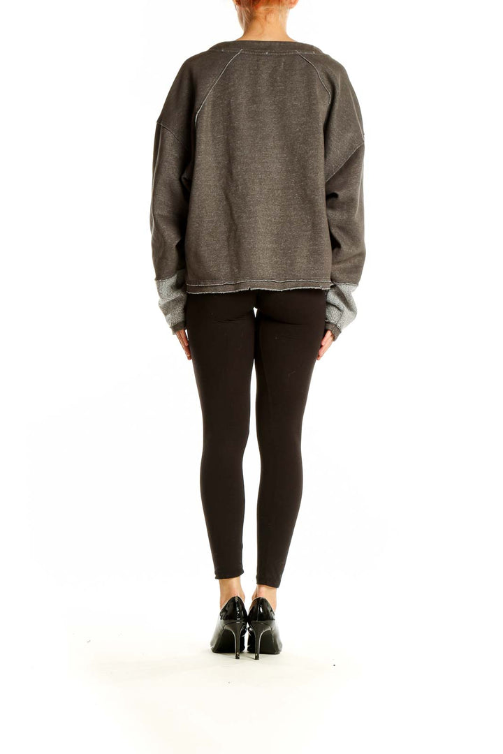 Side view of WE THE FREE gray cropped sweatshirt showing oversized fit