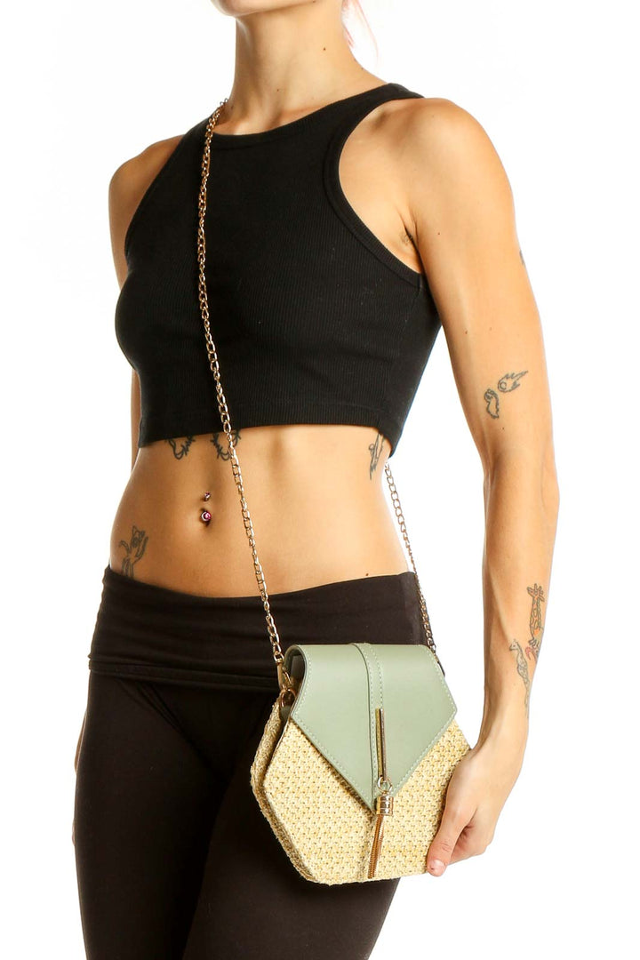 Front view of SilkRoll sage green and straw hexagonal clutch with chain strap