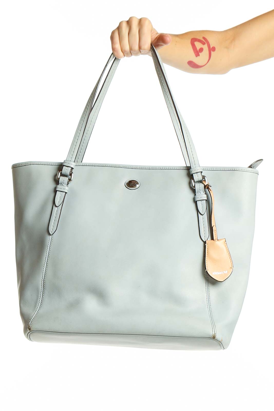 Front view of light blue leather Coach tote bag with adjustable straps
