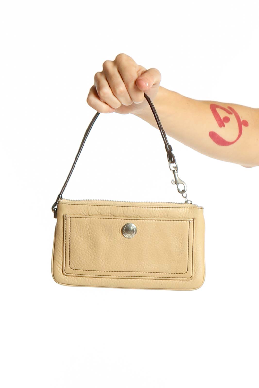Front view of beige Coach leather wristlet clutch with front pocket