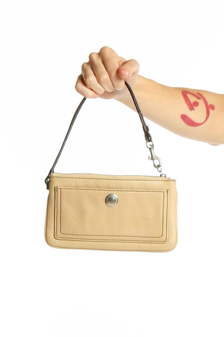 Front view of beige Coach leather wristlet clutch with front pocket