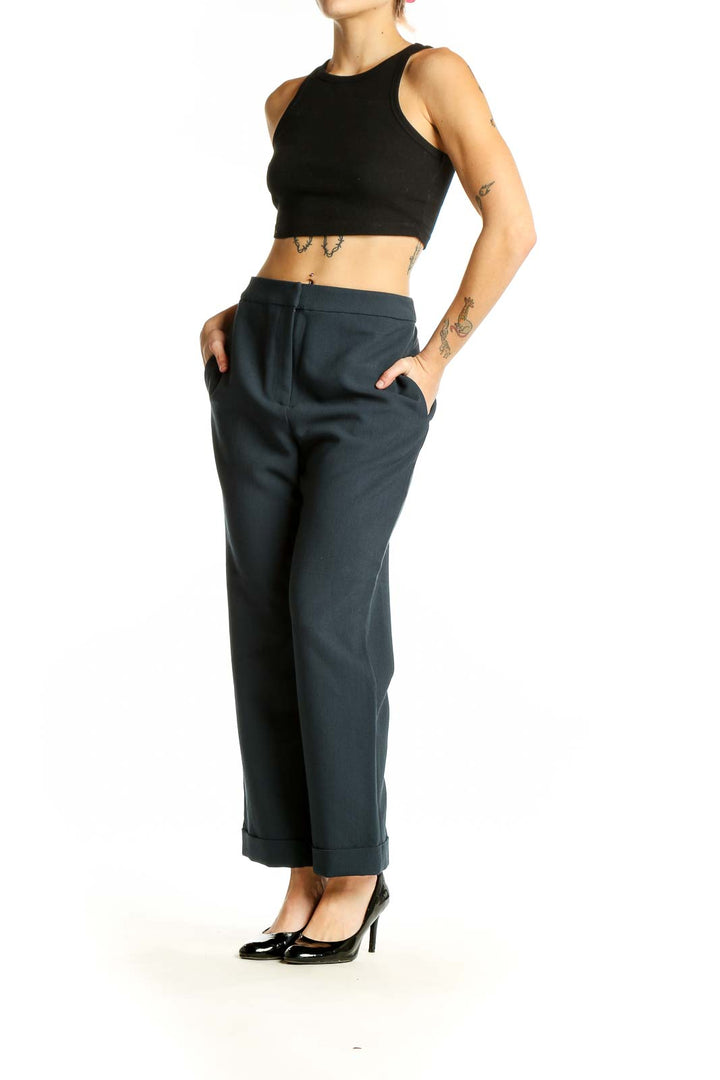 Front view of Finders Keepers navy wide-leg trousers on model