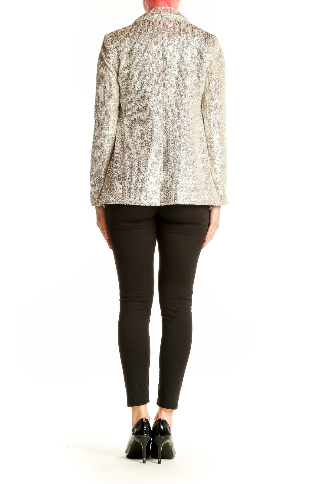 Side view of model wearing Banana Republic silver sequin blazer with black outfit