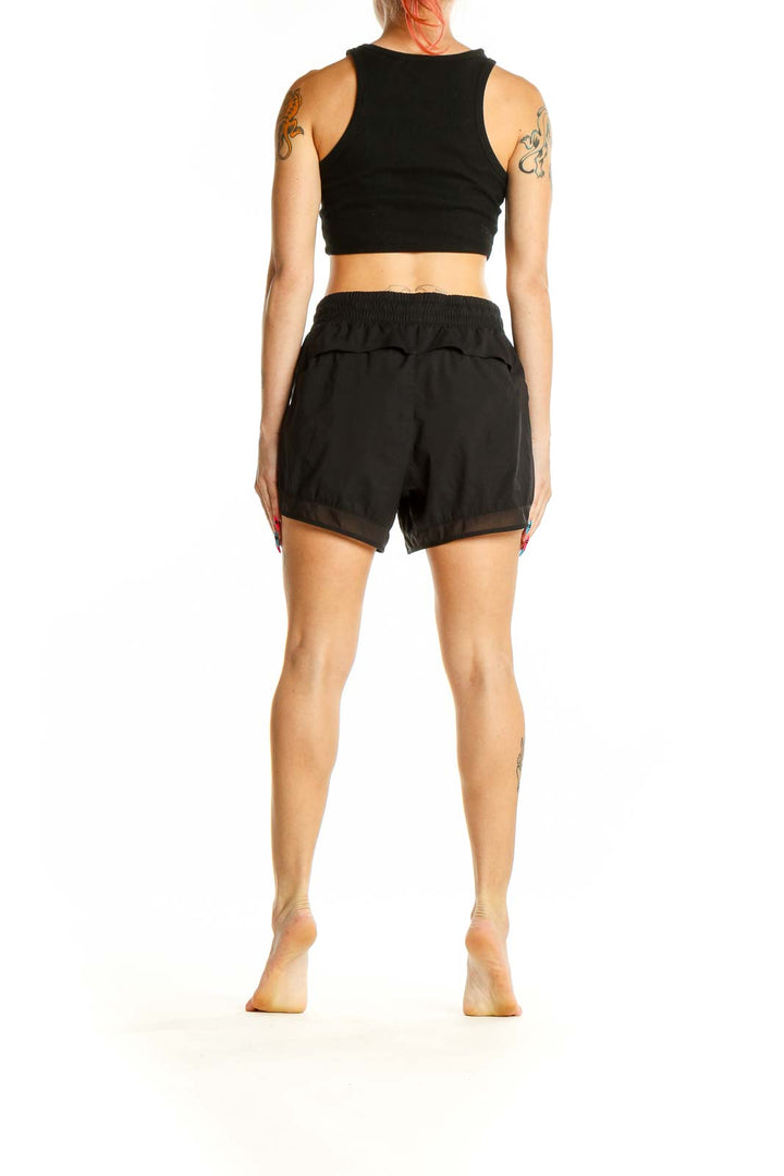 Side view of woman wearing black Athleta activewear set